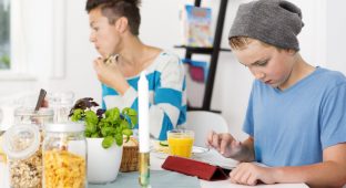 Mother and son having breakfast together in the morning