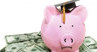 frowning piggy bank with graduation cap, on cash