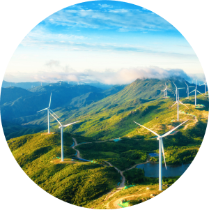 View of a windfarm on top of a green mountain range