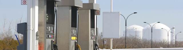 Three pumps at a gas station. 