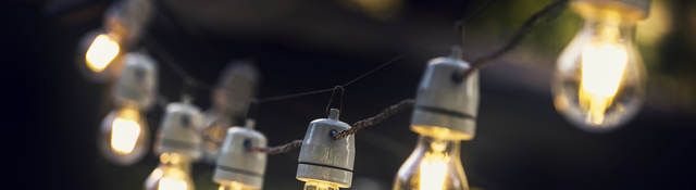 A strand of string lights in an outdoor setting. 