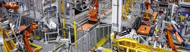 Robots putting cars together in a factory