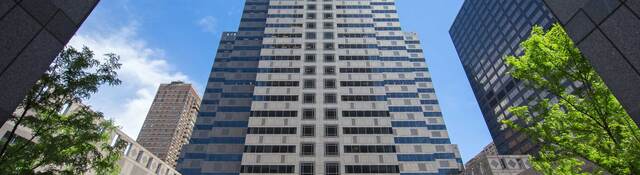 Viewing a tall office building surrounded by blue sky