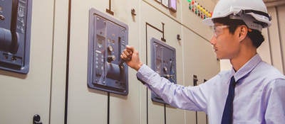 Worker testing a switch