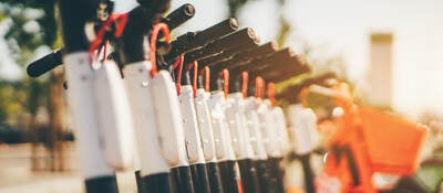 A row of outdoor scooters