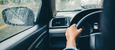 Man driving car in rain