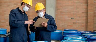 Men in PPE working in chemical warehouse