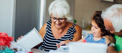 Grandparents sort recyclables with their grandchild