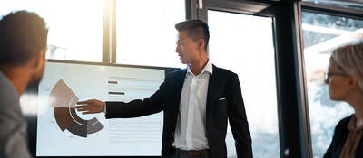 young businessman giving a presentation to his colleagues