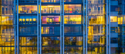 Business office building windows illuminated at dusk