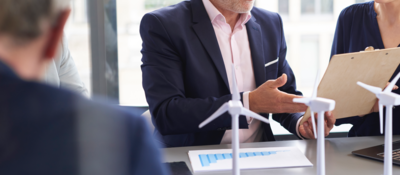 Business people discussing a wind turbine model