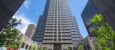 Viewing a tall office building surrounded by blue sky