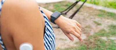 Woman checking a smartwatch to see her blood sugar level