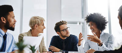 A group of businesspeople sitting together in a meeting.