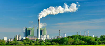 Steaming ignite-fired power plant in a green landscape