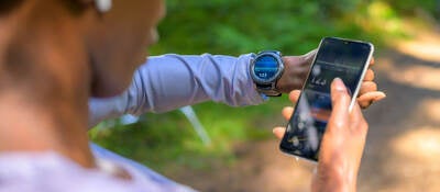 A person using tracker software and a smart watch