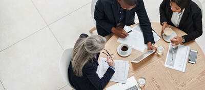 Overhead view of three business professionals having a meeting