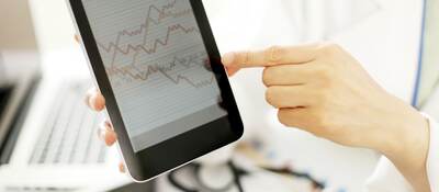 Doctor hands hold and show digital tablet pc to patient.