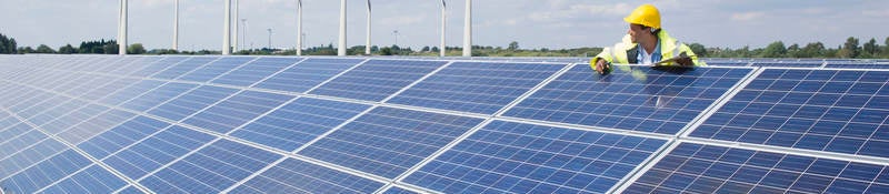 Man checking on solar panels