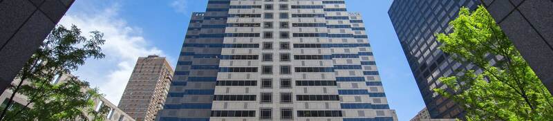 Viewing a tall office building surrounded by blue sky