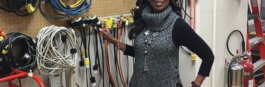 LeVette Martin stands before electrical equipment in UL lab