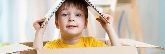 kid boy playing in a toy house