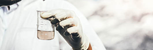 Close-up of person testing water sample.