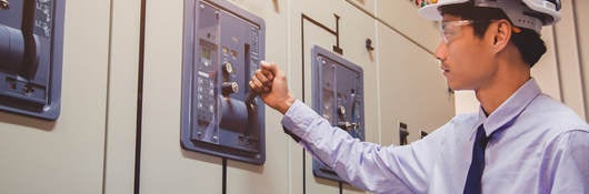 Worker testing a switch