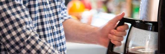 Consumer using a coffee maker