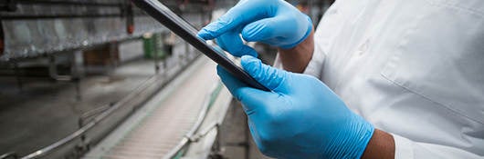 People collaborating on a tablet in a warehouse 