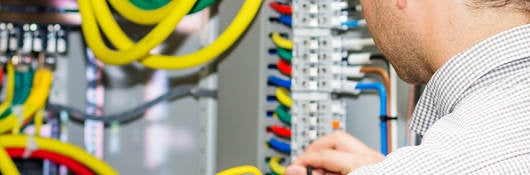 Electrical engineer working in electrical cabinet