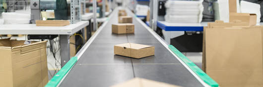 Photo of cardboard boxes on a conveyor belt