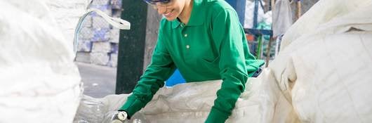 woman looking at plastic recycled bottles