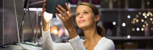 Women looking at desk lamps in a store