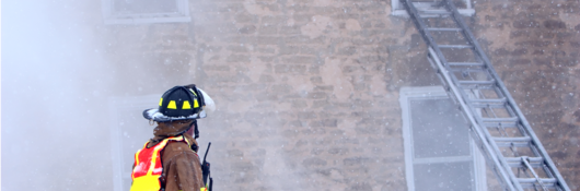 firefighter with radio at burning building