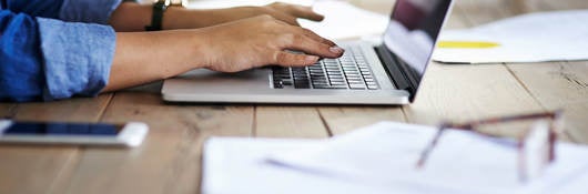 Person sitting at her desk receiving training