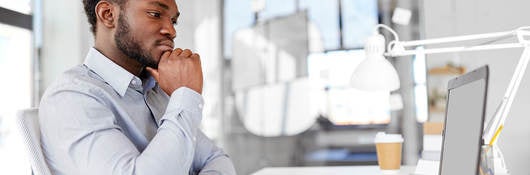 Man sitting in front of computer doing online training