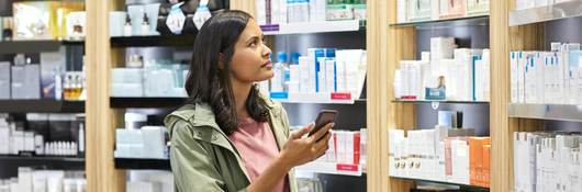 Woman shopping shelves of products.