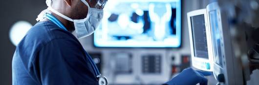 Surgeon looking at a monitor in an operating room