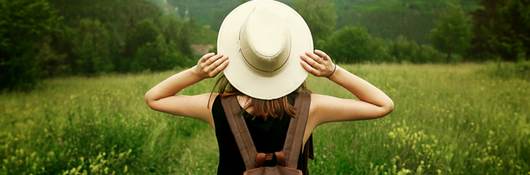 Woman traveler with backpack in nature