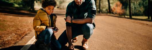 Father and son watch a radio-controlled car together