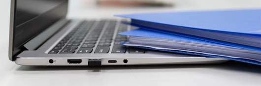 Folders and laptop on a desk.