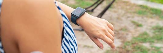 Woman checking a smartwatch to see her blood sugar level