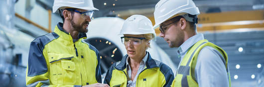 Three engineers discussing a project