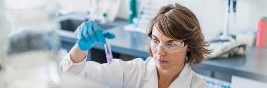 Scientist inspecting sample in a test tube