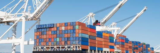 Cargo ship being loaded in harbor