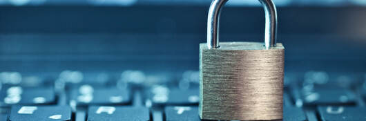 an image of a locked padlock sitting on a keyboard