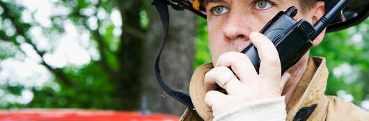 Firefighter talking on a radio