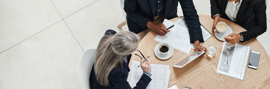 Overhead view of three business professionals having a meeting