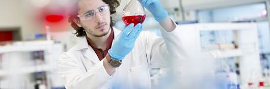 Chemistry research student working in laboratory.